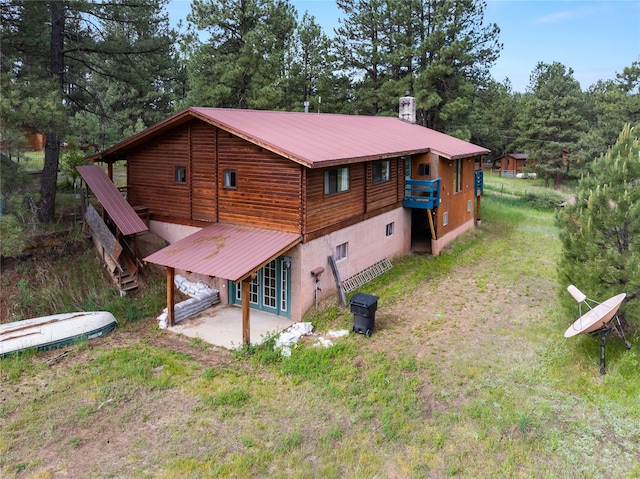 19 Canoe Ct, Jemez Springs, NM 87025 - back of property featuring a patio area, a metal roof, and french doors