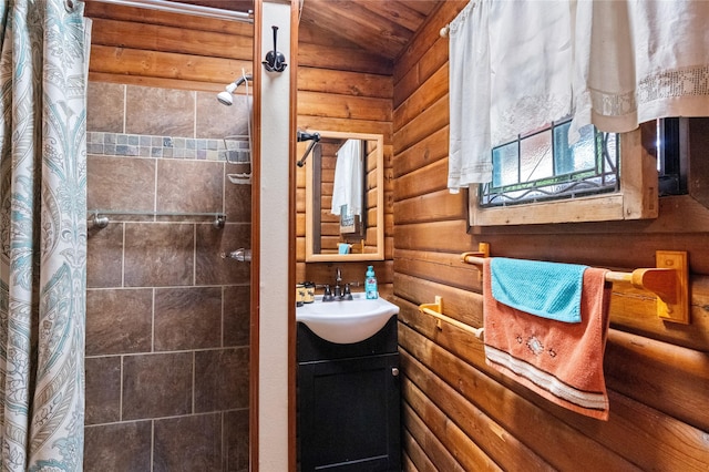 19 Canoe Ct, Jemez Springs, NM 87025 - full bathroom featuring rustic walls, tiled shower, and vanity