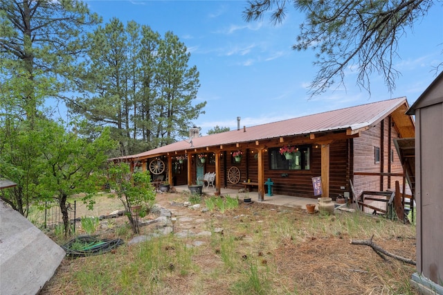 19 Canoe Ct, Jemez Springs, NM 87025 - view of front facade with a metal roof and a patio