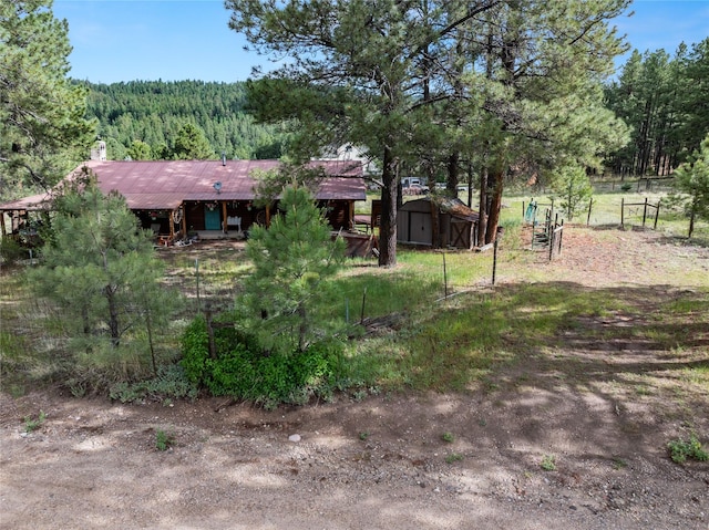 19 Canoe Ct, Jemez Springs, NM 87025 - rear view of property with a storage shed and a forest view