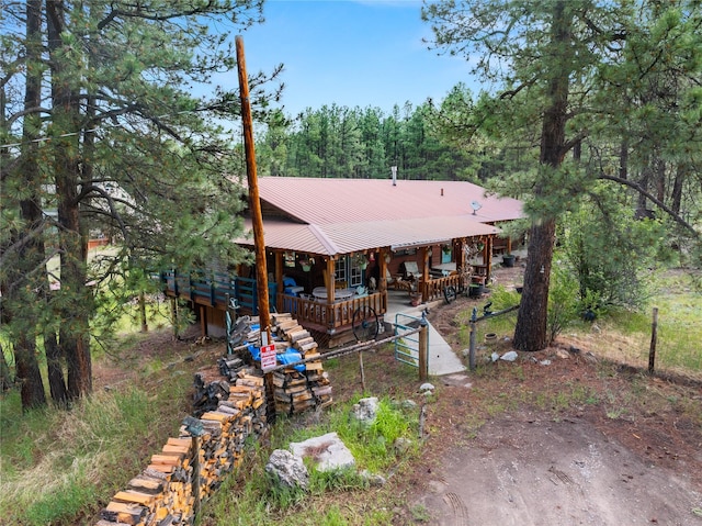 19 Canoe Ct, Jemez Springs, NM 87025 - rear view of property featuring a metal roof, a wooded view, and a porch