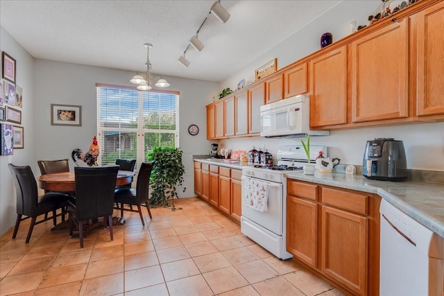 3 Hunters Run, Santa Fe, NM 87508 - kitchen with white appliances, light countertops, light tile patterned floors, track lighting, and a chandelier