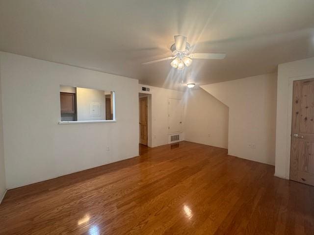 2210 Miguel Chavez Unit 1816, Santa Fe, NM 87505 - unfurnished living room featuring wood finished floors and a ceiling fan