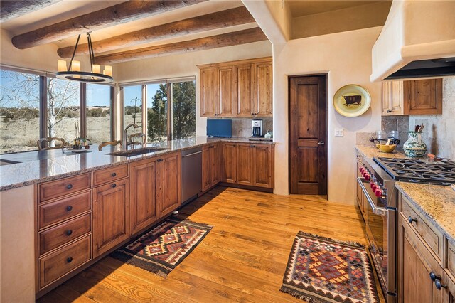 5 N Brisa Fresca, Santa Fe, NM 87506 - kitchen featuring appliances with stainless steel finishes, custom range hood, beamed ceiling, light wood finished floors, and backsplash
