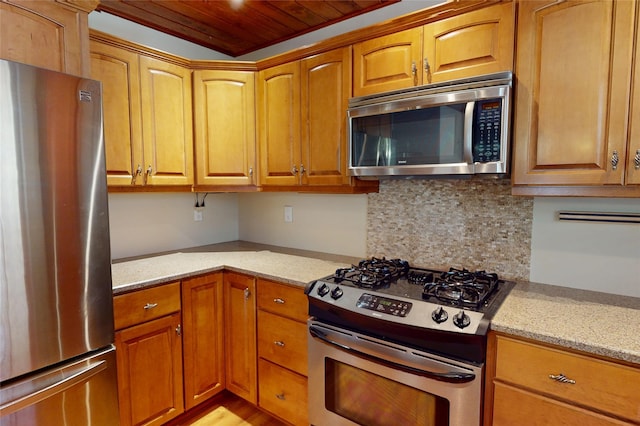 986 Alamo Rd, Los Alamos, NM 87544 - kitchen with stainless steel appliances, wood ceiling, light stone countertops, decorative backsplash, and brown cabinets