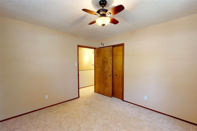 986 Alamo Rd, Los Alamos, NM 87544 - unfurnished bedroom with light carpet, a closet, and ceiling fan