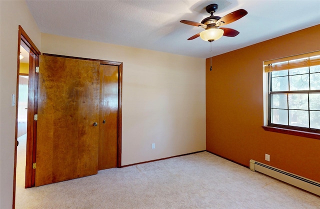 986 Alamo Rd, Los Alamos, NM 87544 - unfurnished bedroom featuring a baseboard radiator, a closet, carpet flooring, and a ceiling fan