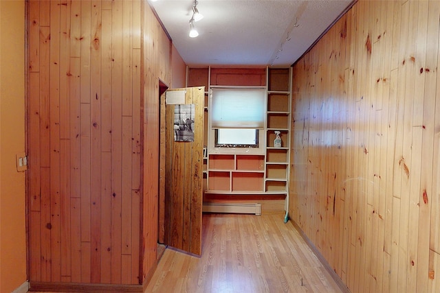986 Alamo Rd, Los Alamos, NM 87544 - hall featuring wood walls, light wood-style floors, and a baseboard radiator