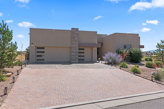 5611 Desert Sky, Rio Rancho, NM 87144 - view of front of property with a garage, stucco siding, and decorative driveway