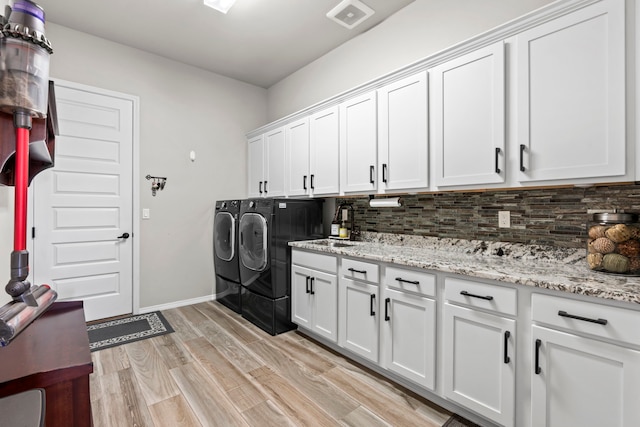 5611 Desert Sky, Rio Rancho, NM 87144 - laundry room featuring cabinet space, separate washer and dryer, and light wood-type flooring
