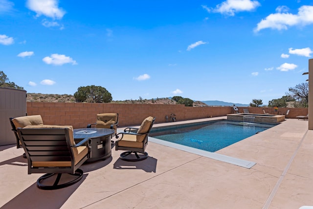 5611 Desert Sky, Rio Rancho, NM 87144 - view of swimming pool with an outdoor fire pit, a fenced backyard, a patio area, and a pool with connected hot tub