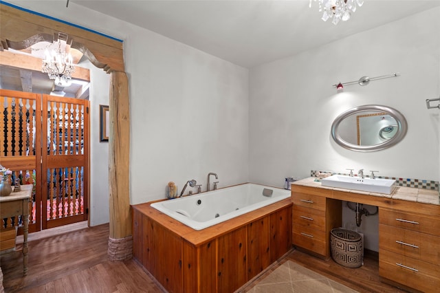 3B Camino Miguel, Santa Fe, NM 87506 - bathroom featuring a chandelier, a whirlpool tub, and wood finished floors