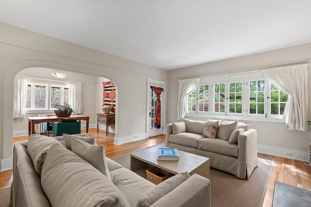 359 Garcia St, Santa Fe, NM 87501 - living room with arched walkways, light wood-style flooring, and healthy amount of natural light