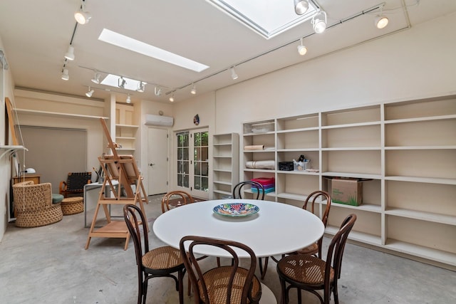 359 Garcia St, Santa Fe, NM 87501 - dining area with track lighting, concrete flooring, a skylight, and a wall mounted AC