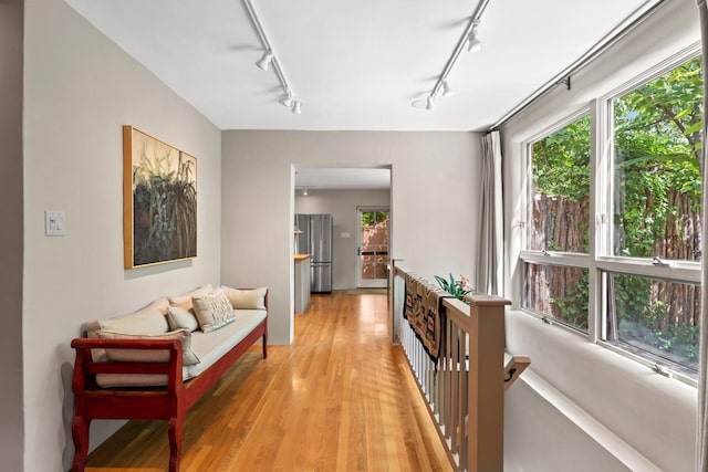 359 Garcia St, Santa Fe, NM 87501 - corridor featuring track lighting, healthy amount of natural light, an upstairs landing, and light wood finished floors