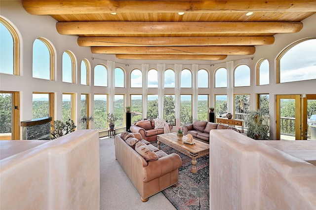 51 Coyote Mountain Rd, Santa Fe, NM 87505 - living room with a wood ceiling with exposed beams, plenty of natural light, light carpet, a towering ceiling, and recessed lighting