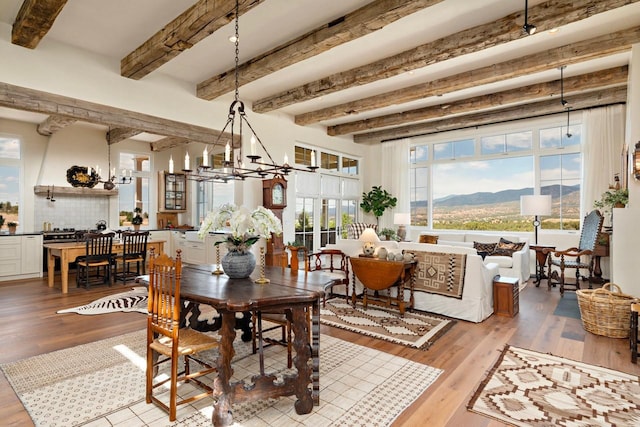 102 San Rafael Dr, Santa Fe, NM 87506 - dining room featuring beam ceiling, wood finished floors, a chandelier, and a mountain view