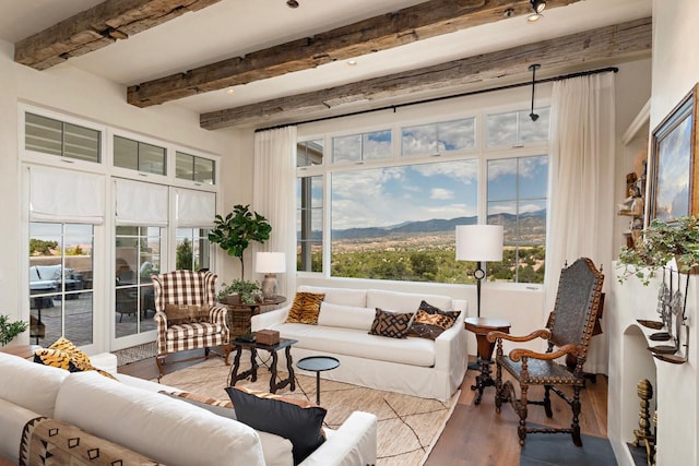 102 San Rafael Dr, Santa Fe, NM 87506 - living room featuring wood finished floors, beamed ceiling, and a mountain view