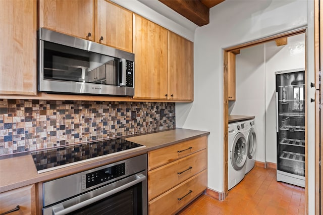134 W Houghton St Unit D, Santa Fe, NM 87505 - kitchen featuring stainless steel appliances, separate washer and dryer, tasteful backsplash, and brick patterned flooring