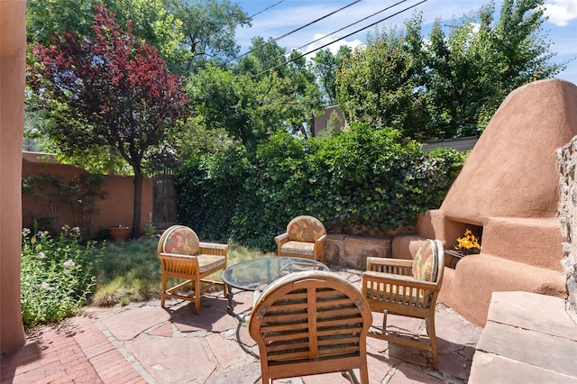 134 W Houghton St Unit D, Santa Fe, NM 87505 - fenced backyard featuring a lit fireplace and a patio area