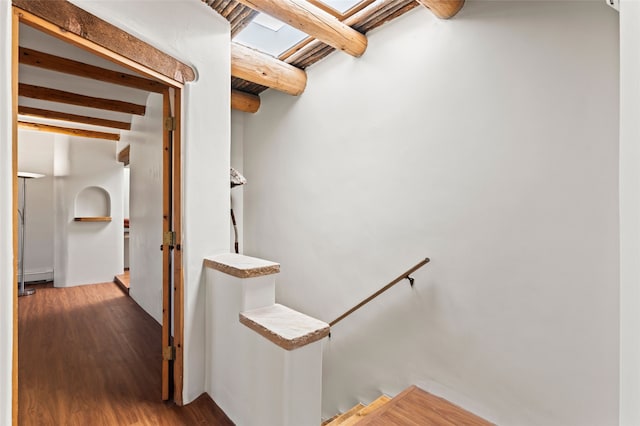 134 W Houghton St Unit D, Santa Fe, NM 87505 - stairway featuring beamed ceiling, wood finished floors, and baseboard heating