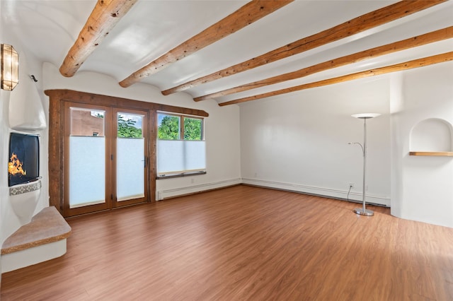 134 W Houghton St Unit D, Santa Fe, NM 87505 - unfurnished living room with beam ceiling, wood finished floors, and baseboard heating
