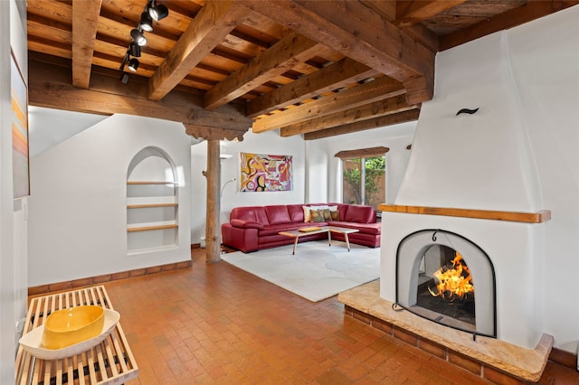 134 W Houghton St Unit D, Santa Fe, NM 87505 - living area featuring a wood ceiling with exposed beams, brick floors, and track lighting