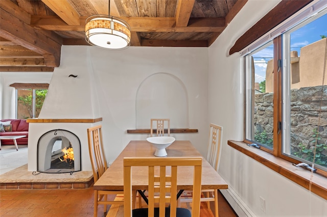 134 W Houghton St Unit D, Santa Fe, NM 87505 - dining space featuring a wooden ceiling with exposed beams, brick floors, and a baseboard heating unit
