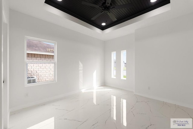 6245 Tiger Dr, Brownsville, TX 78521 - unfurnished room with a tray ceiling, marble tiled floors, baseboards, recessed lighting, and a ceiling fan