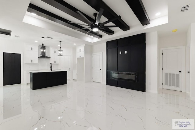 6245 Tiger Dr, Brownsville, TX 78521 - living room with recessed lighting, beamed ceiling, baseboards, a ceiling fan, and light marble finish floors