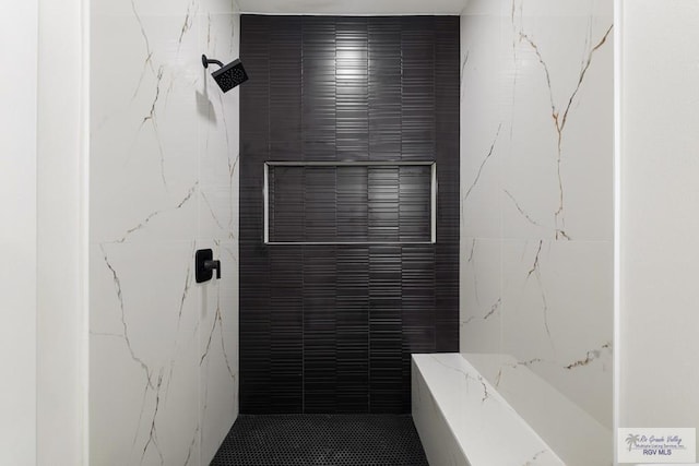6245 Tiger Dr, Brownsville, TX 78521 - bathroom featuring tile walls and tiled shower
