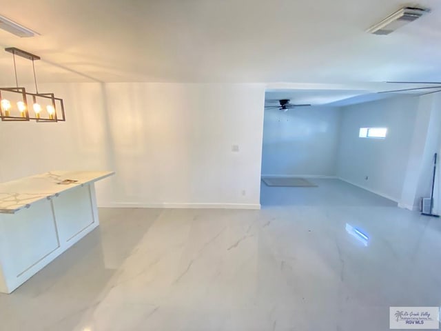 530 Star Ruby Ln, Brownsville, TX 78521 - below grade area featuring baseboards, a chandelier, and a ceiling fan