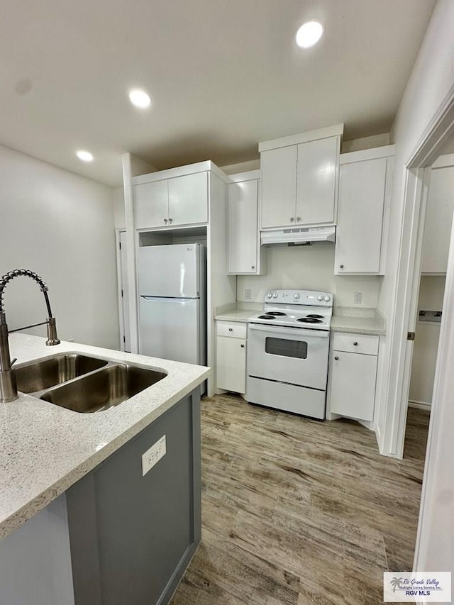 kitchen featuring white cabinetry, sink, white appliances, and light wood-type flooring