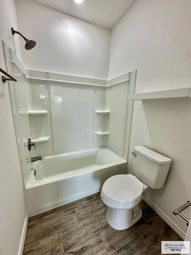 bathroom with wood-type flooring, toilet, and shower / washtub combination