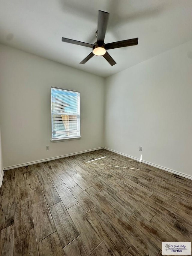 empty room featuring hardwood / wood-style flooring and ceiling fan