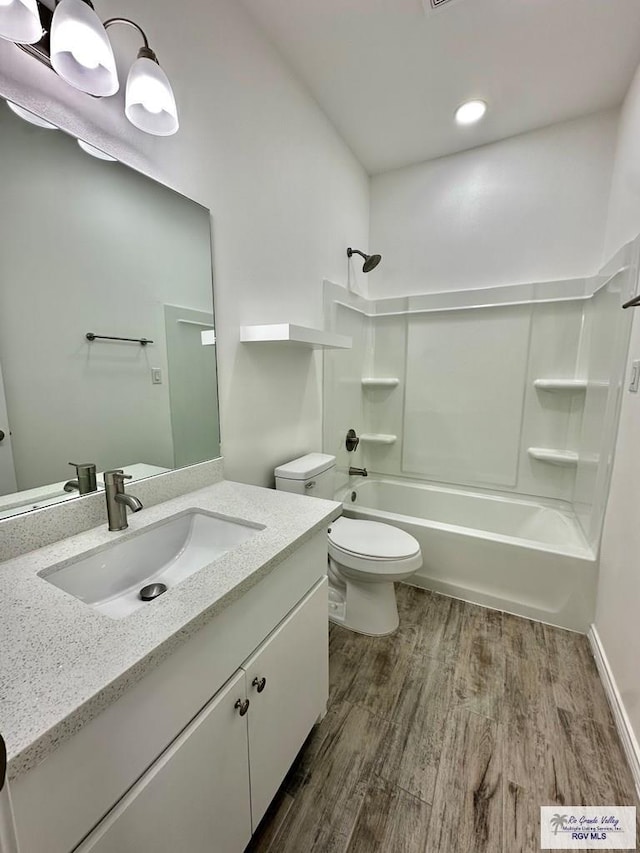 full bathroom featuring bathing tub / shower combination, toilet, vanity, and hardwood / wood-style flooring