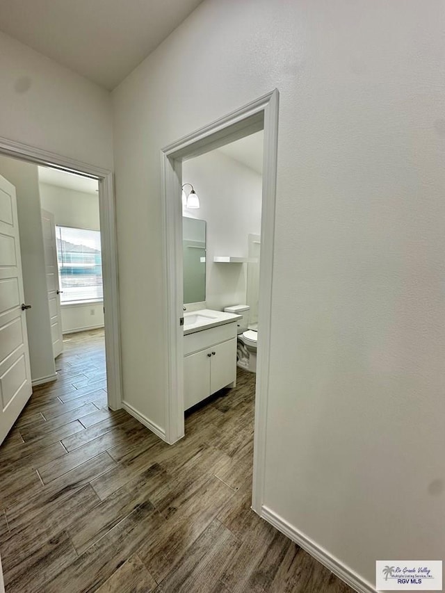 corridor with hardwood / wood-style floors