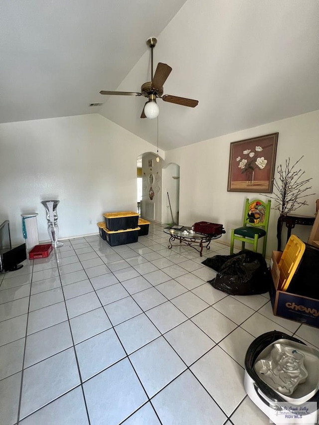 sitting room featuring lofted ceiling, light tile patterned floors, and ceiling fan