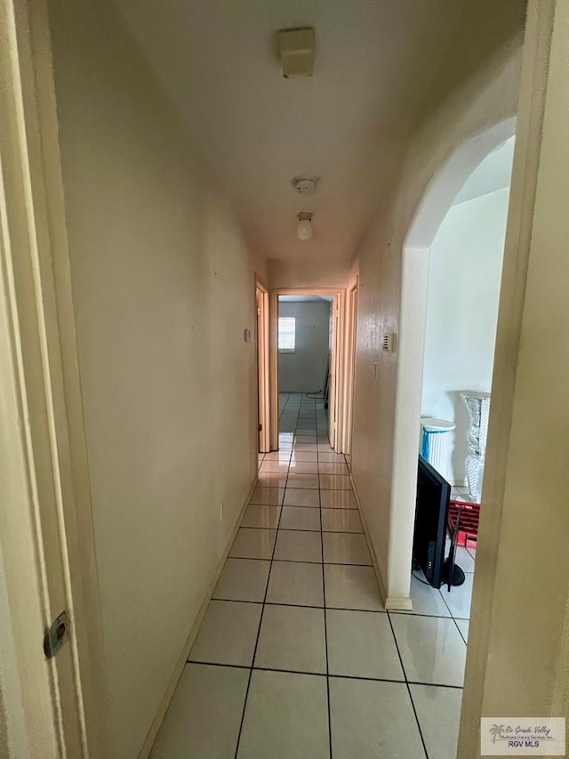 hall featuring light tile patterned flooring