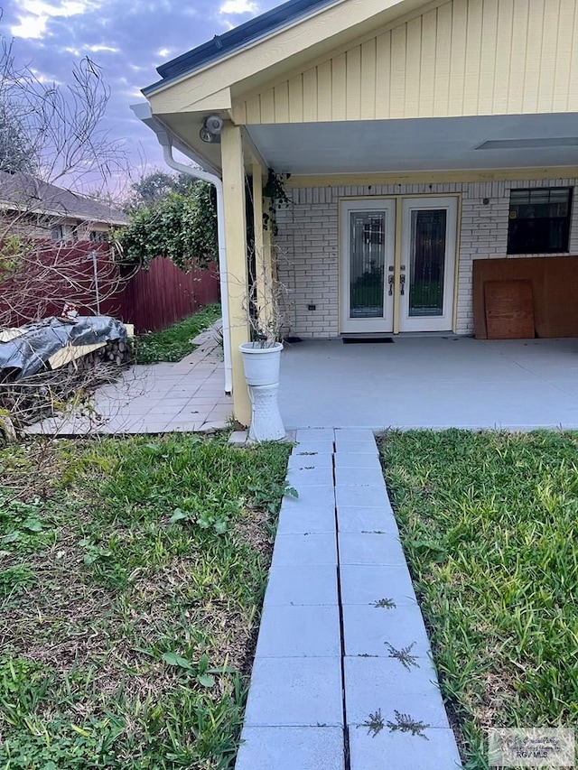 view of exterior entry featuring a patio
