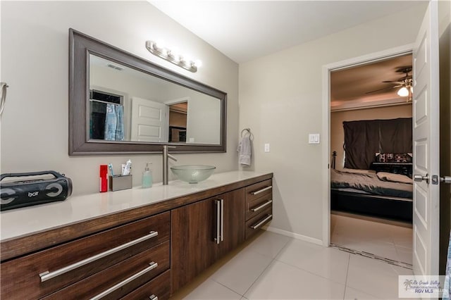 514 Hunt Ave, San Juan, TX 78589 - ensuite bathroom featuring baseboards, visible vents, tile patterned floors, vanity, and connected bathroom