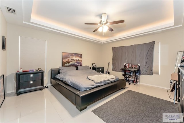 514 Hunt Ave, San Juan, TX 78589 - tiled bedroom featuring a tray ceiling, baseboards, a ceiling fan, and visible vents
