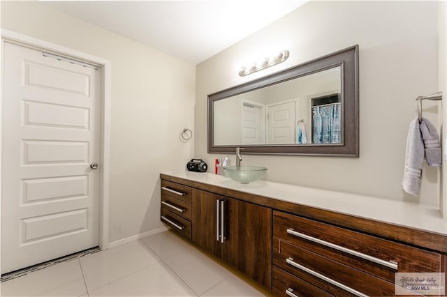 514 Hunt Ave, San Juan, TX 78589 - bathroom featuring vanity, baseboards, and tile patterned floors