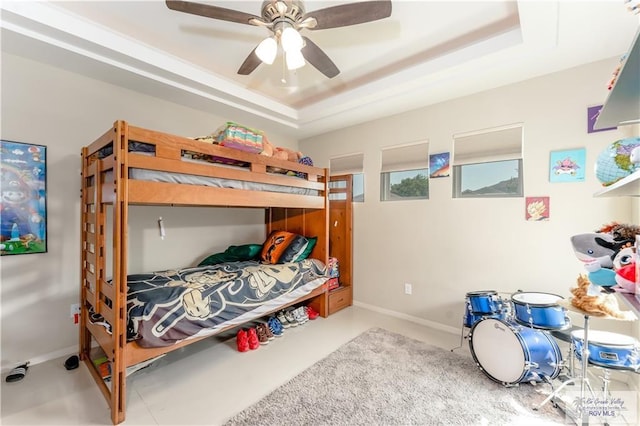 514 Hunt Ave, San Juan, TX 78589 - bedroom featuring a ceiling fan, baseboards, and a tray ceiling