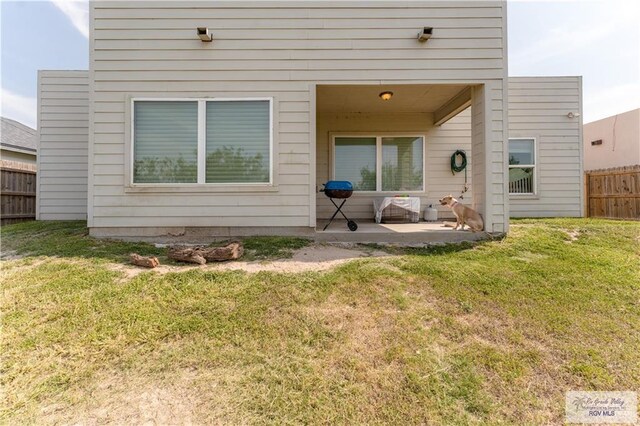 514 Hunt Ave, San Juan, TX 78589 - rear view of house featuring a yard, a patio area, and fence