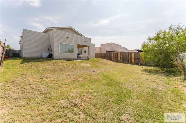 514 Hunt Ave, San Juan, TX 78589 - back of property with central air condition unit, a yard, and a fenced backyard