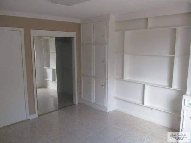 unfurnished bedroom featuring light tile patterned floors and ornamental molding