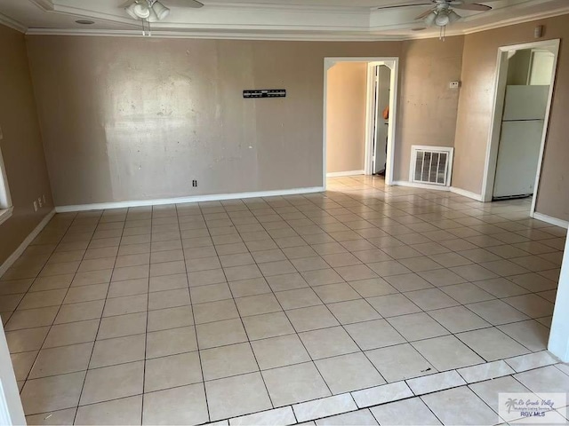 empty room with visible vents, crown molding, baseboards, light tile patterned floors, and a ceiling fan