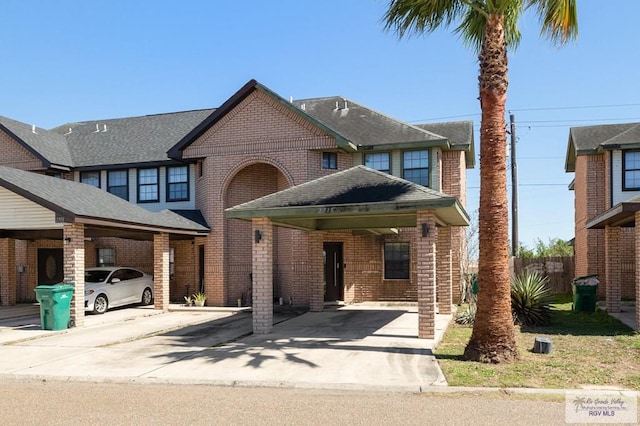 view of front of home featuring concrete driveway and brick siding