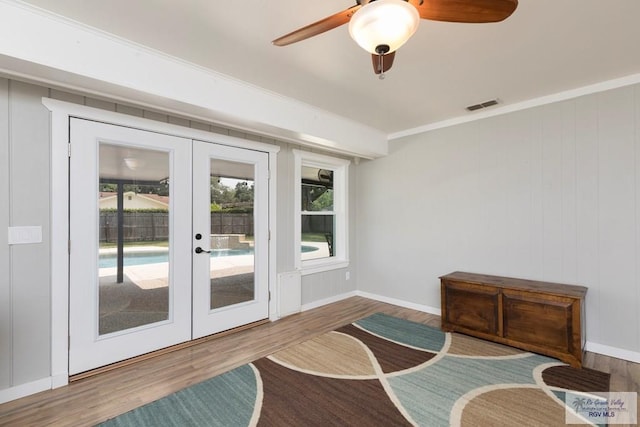 1409 Pine Ct, Harlingen, TX 78550 - sitting room featuring french doors, wood finished floors, a ceiling fan, crown molding, and baseboards